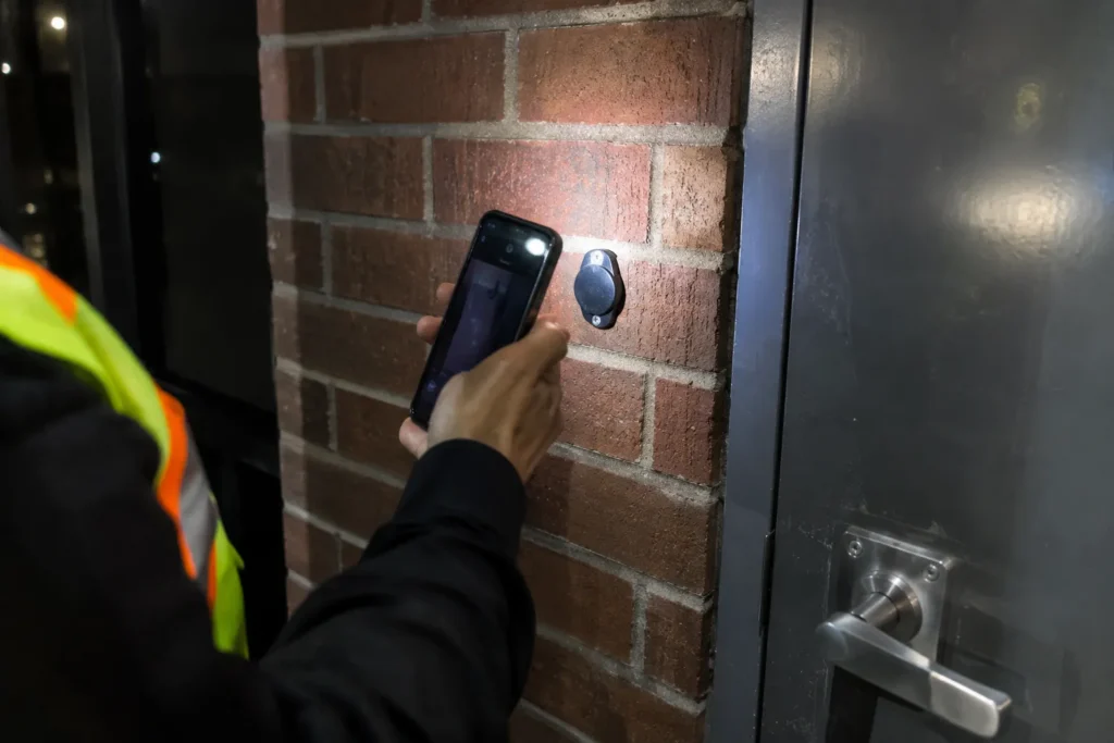 Patrol guard scanning a checkpoint tag during a site visit