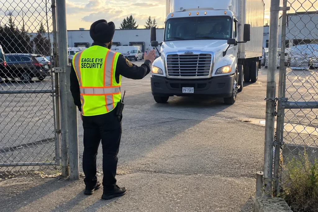 Security guard checking a delivery truck at a warehouse gate